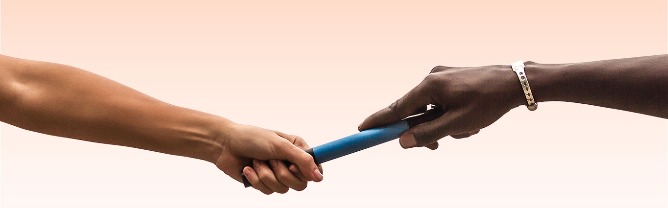 Two arms passing a baton to each other