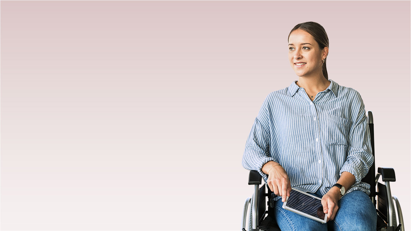 Young businesswoman with tablet sitting in wheelchair in office