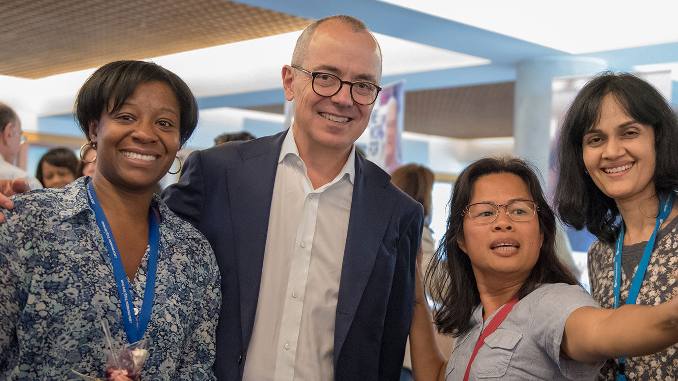 Giovanni Caforio, M.D. Board Chair and CEO posing with employees