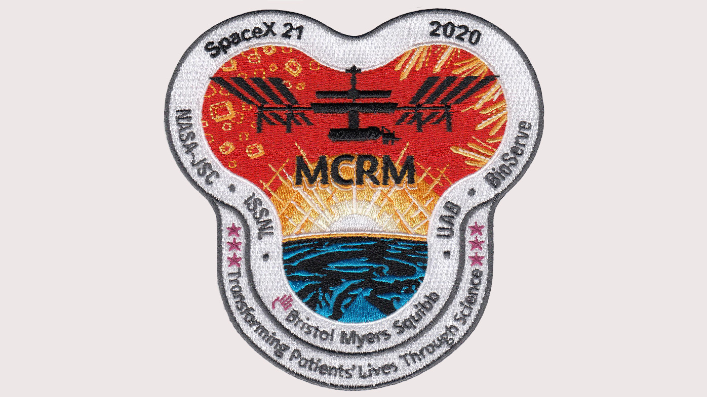 A patch Bristol Myers Squibb developed with the International Space Station Research Lab commemorates the mission. The letters MCRM refer to Monoclonal Crystal Research in Microgravity.